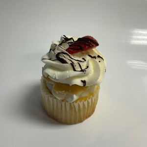 vanilla cupcake with whipped cream and strawberries
